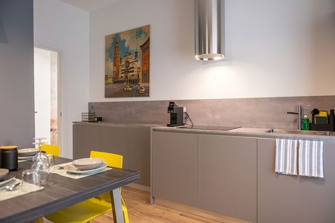 Cucina dell'Appartamento Battistero con tavolo apparecchiato e stampa del Duomo di Cremona